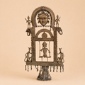 Antique tribal metal sculpture in focus