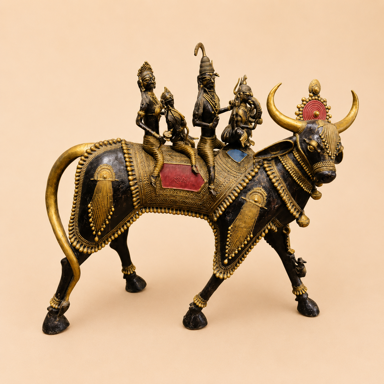 Decorative bull with ornate riders sculpture