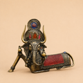 Intricate brass elephant ornament on beige