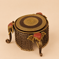 Ornate brass elephant stool with chain fringe