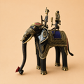 Ornate elephant sculpture with brass riders