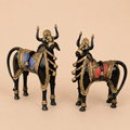Ornate golden bull figurines on beige background